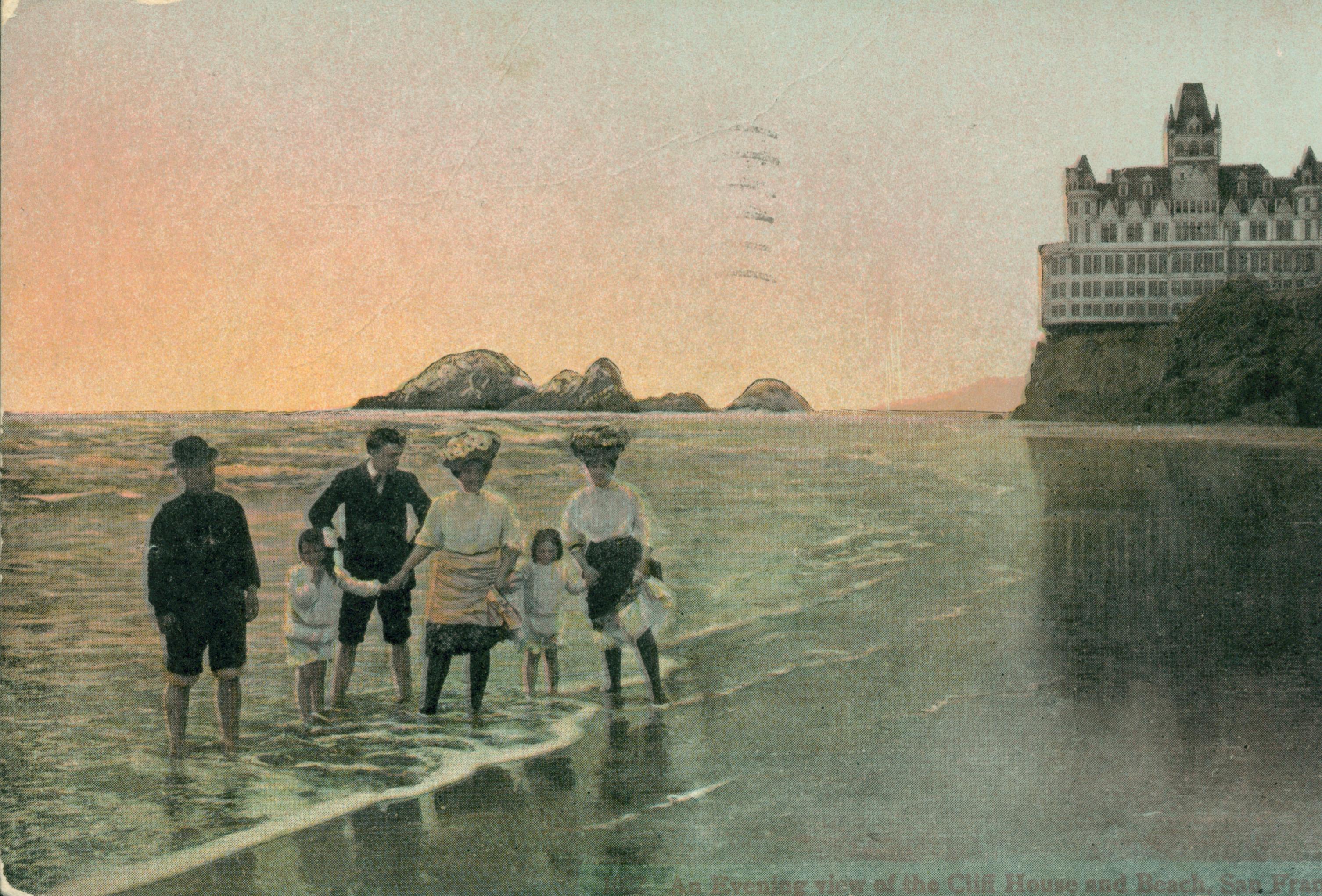 Shows the San Francisco Cliff House and Seal Rocks at sunset, with a family posed on the beach in foreground.